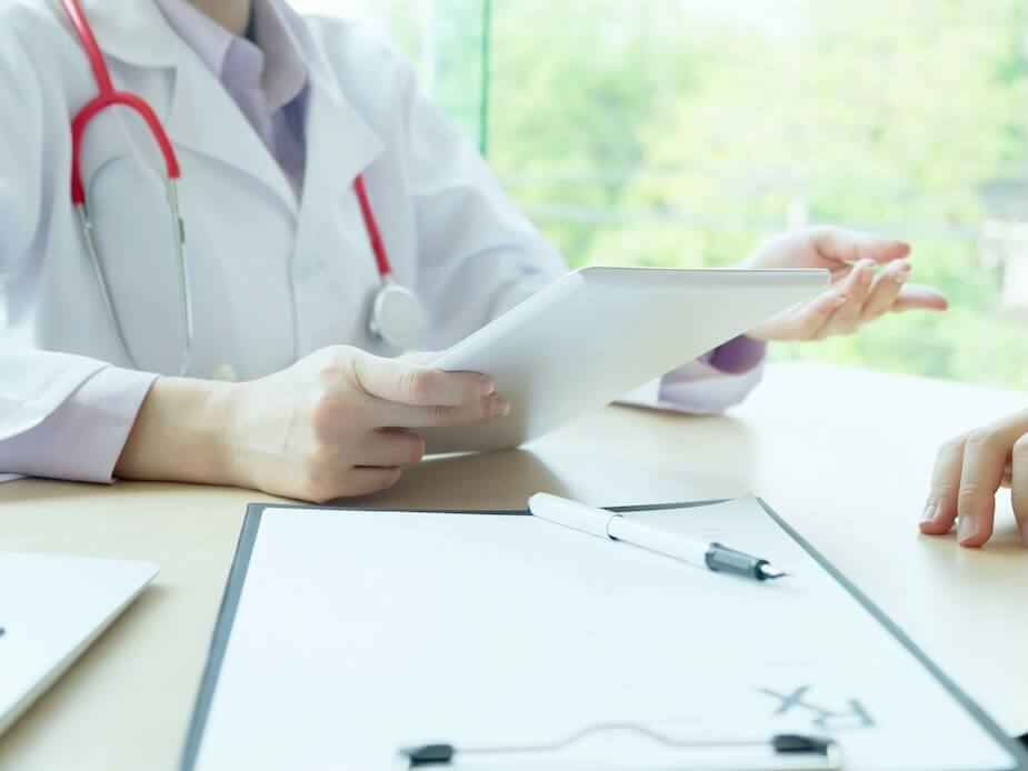 doctor checking patient doctor examines a patient with a stethoscope health hospital and medical concept