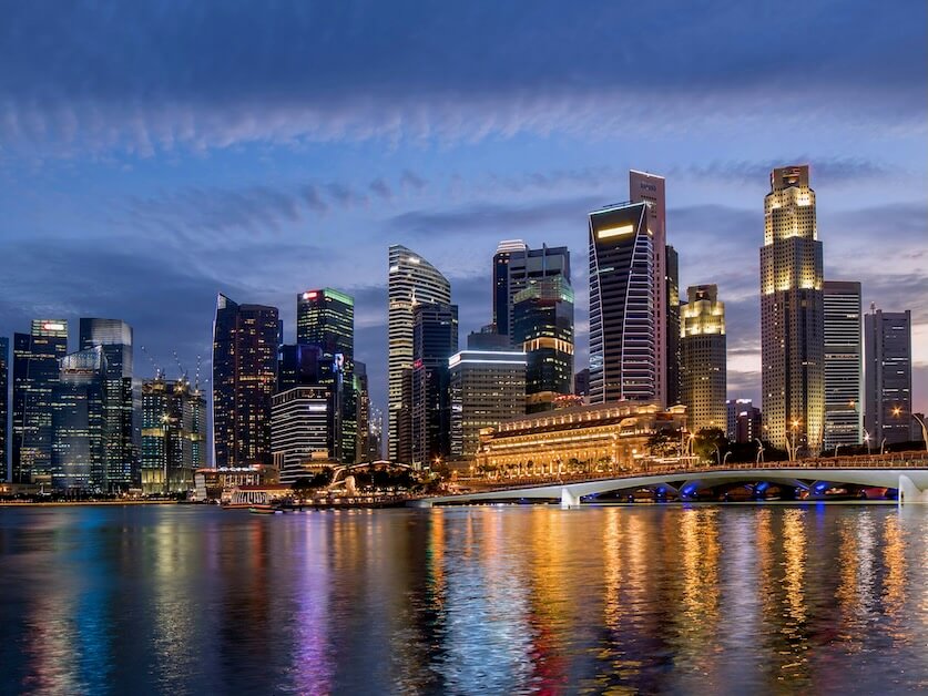 colorful singapore business district skyline after sun set at marina bay