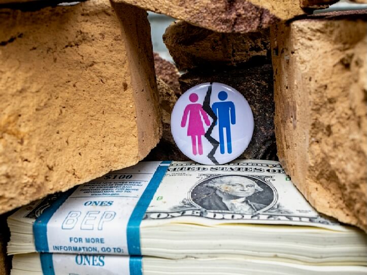 a pile of money with a button on top of it