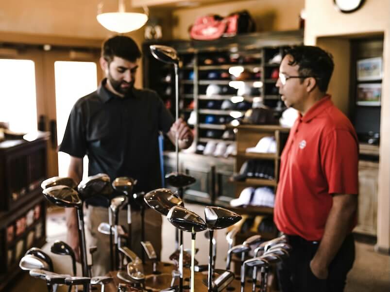 Man Standing Beside Man Holding Gray Golf Club 