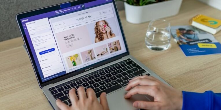 a person typing on a laptop on a table FEATURED IMAGE