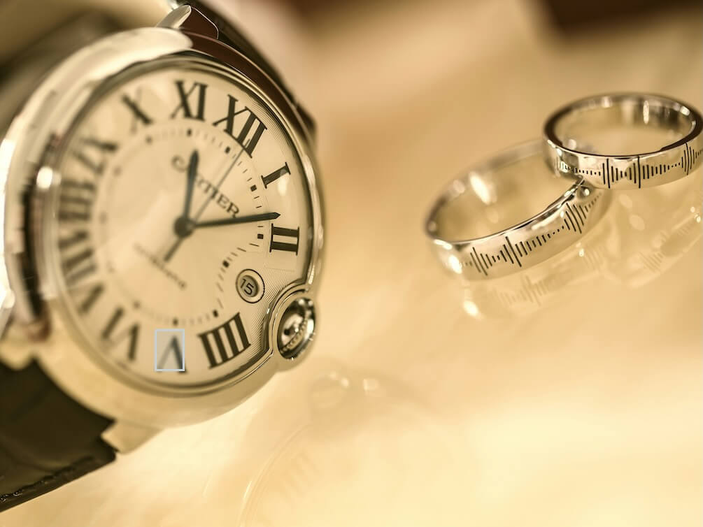 silver colored analog watch near two silver colored rings