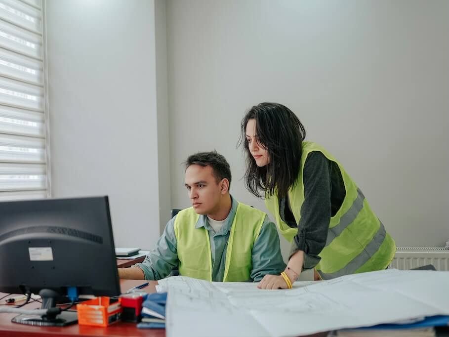 a man and a woman working at a desk