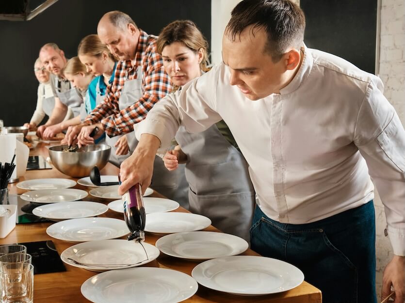 a group of people in a kitchen preparing food