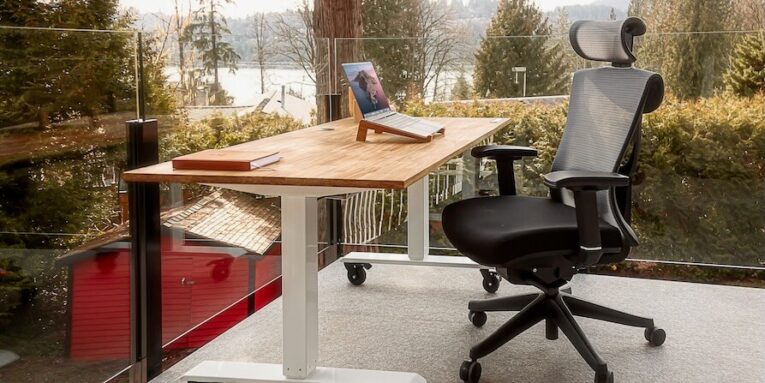 an executive office chair, desk with a laptop on top of it FEATURED IMAGE
