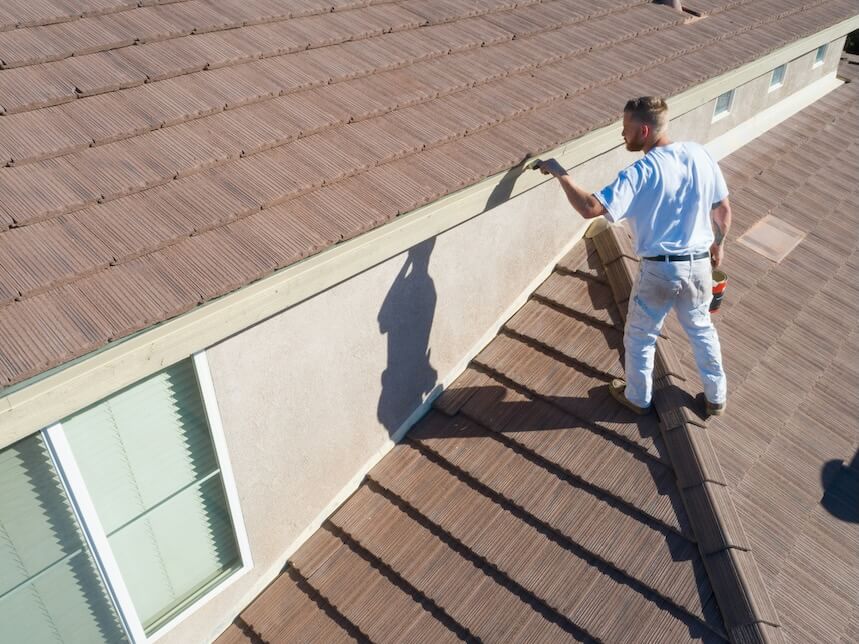 professional painter using a brush to paint house fasciasm