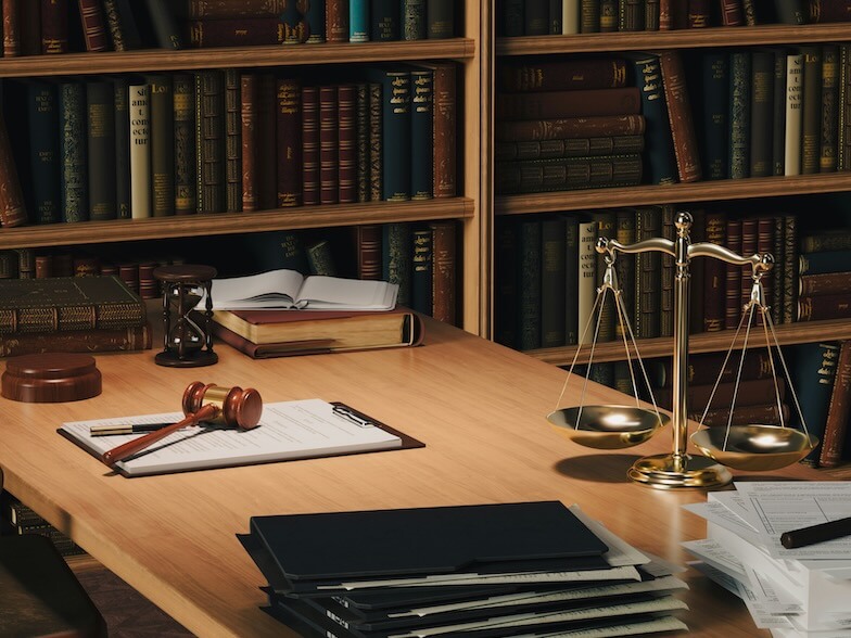 a wooden desk topped with books and a judges scale