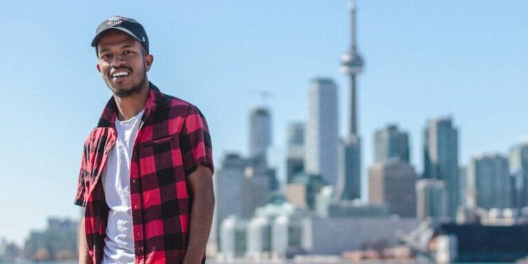 standing man taking selfie beside cn tower canada FEATURED IMAGE