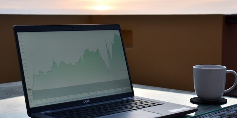 a laptop on a table outside FEATURE IMAGE