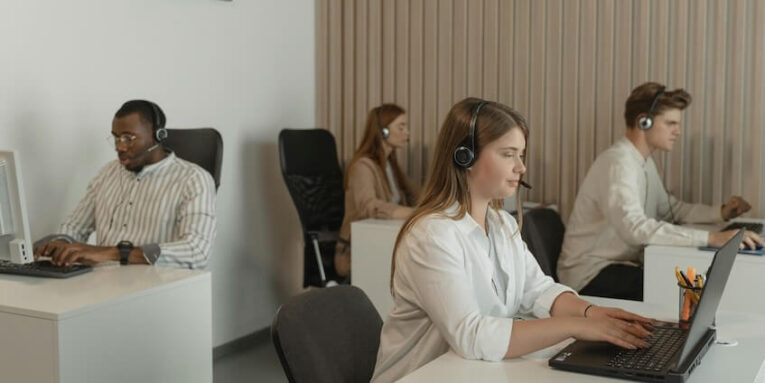 Four People Working in Call Center Office FEATURED IMAGE