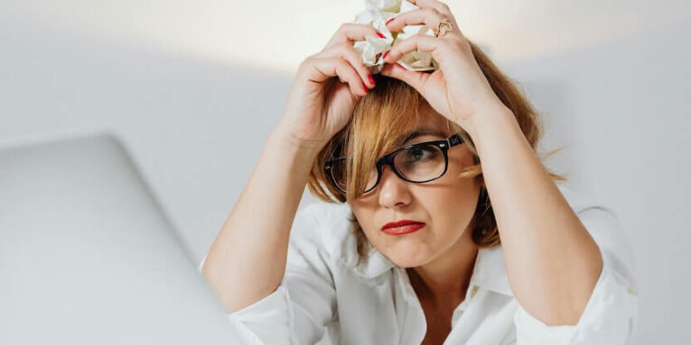 A Short-Haired Woman Leaning on a Table FEATURED IMAGE
