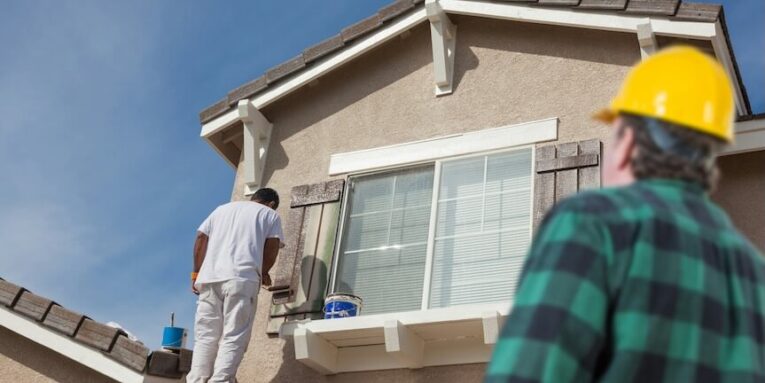 contractor overlooking painter painting house FEATURED IMAGE