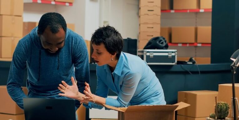 two entrepreneurs checking supply chain on storehouse shelves planning shipment and storage management young people working on business development and logistics stock distribution FEATURED IMAGE
