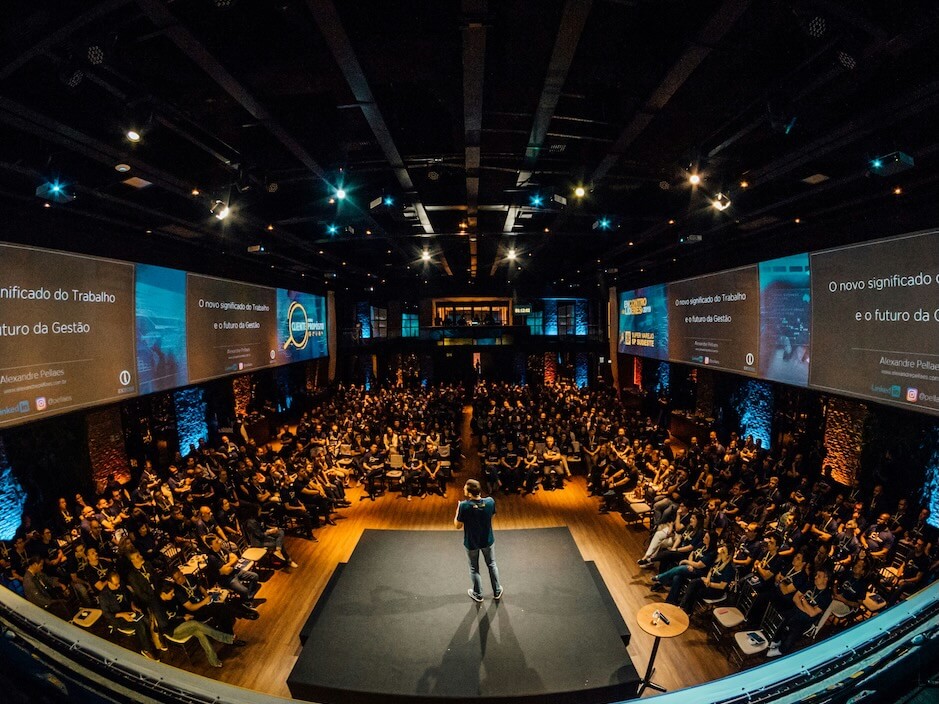 people sitting on chairs watching a guest speaker