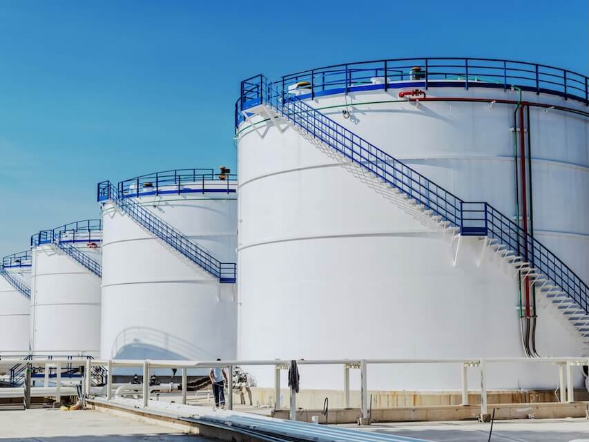 picture of oil tanks at refinery sunny day