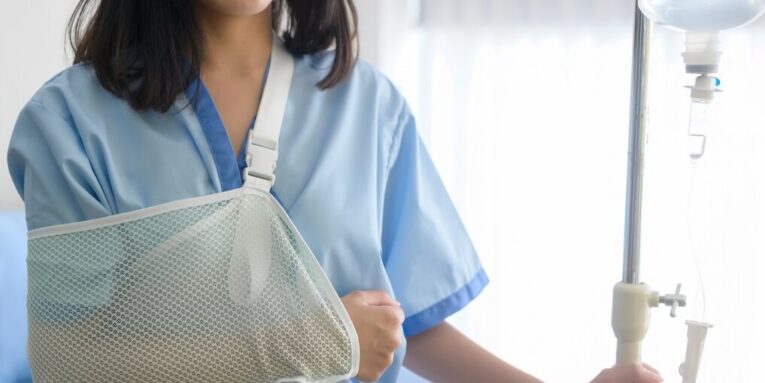 a hopeful and happy young patient woman in hospital healthcare and medical concept FEATURED IMAGE