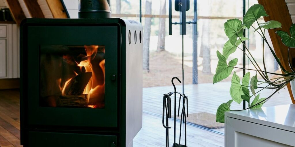 a gas burning stove in a kitchen next to a window FEATURED IMAGE
