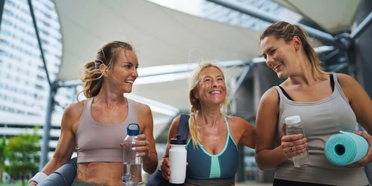 a group of young and old women walking after exercise outdoors in city talking FEATURED IMAGE
