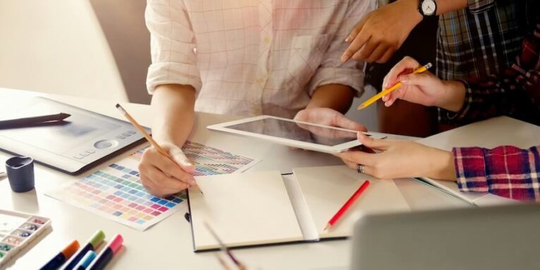 group of artists working on tablet computer at the office FEATURED IMAGE