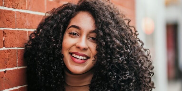 a close up of a person near a brick wall FEATURED IMAGE