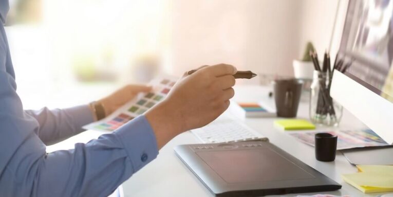 graphic designer working with digital tablet and mouse pen on table and morning light FEATURED IMAGE