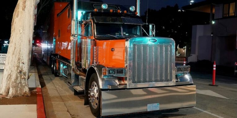 a semi-truck parked on the side of the road FEATURED IMAGE