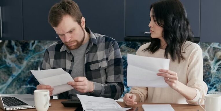 couple looking over invoices FEATURED IMAGE