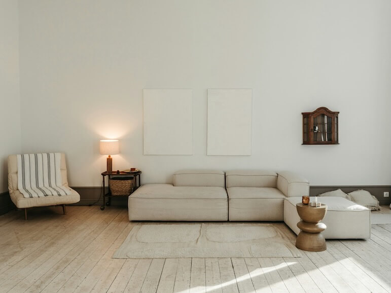 a living room with a white couch and a white chair