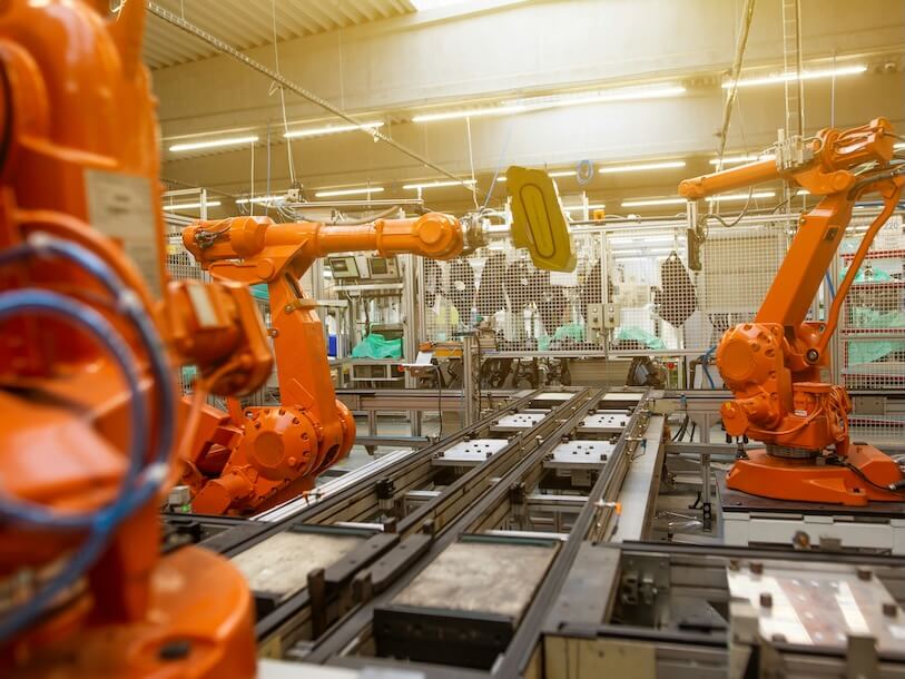 a factory filled with lots of orange machines