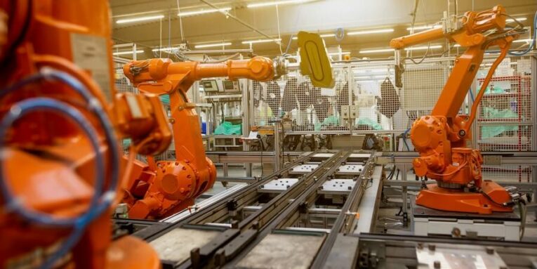 a factory filled with lots of orange machines FEATURED IMAGE