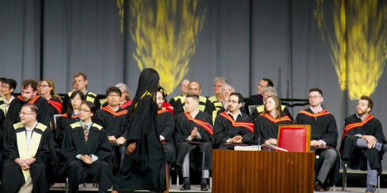 graduate walking on stage FEATURED IMAGE