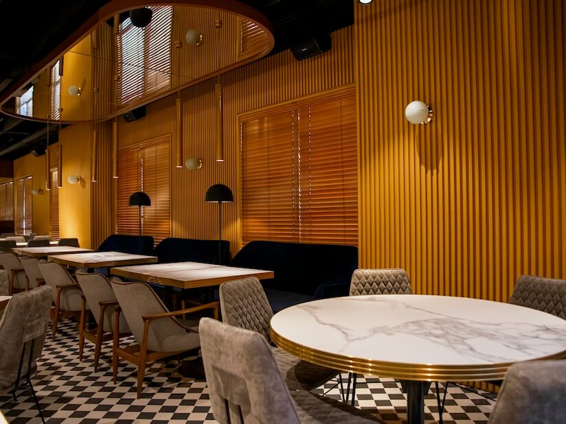 a restaurant with a checkered floor and tables and chairs