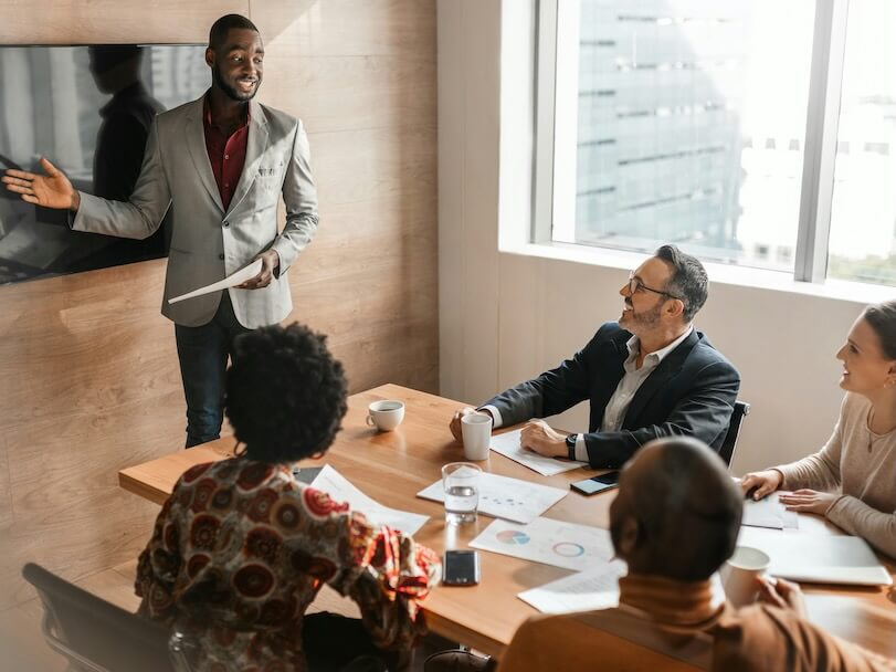 candid and real boardroom meeting with diverse south african business team positivity and success with copy space and light flair