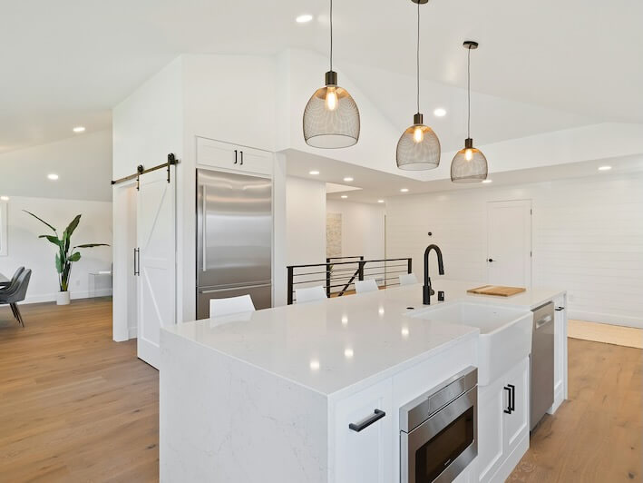 turned on pendant lamps above kitchen island