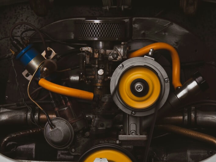 a close up of a car engine with yellow hoses