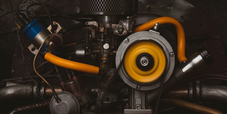 a close up of a car engine with yellow hoses FEATURED IMAGE