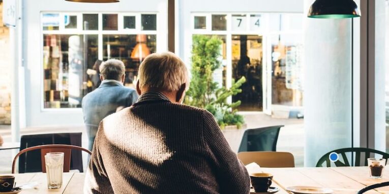 man in chair with table beside coffee FEATURED IMAGE