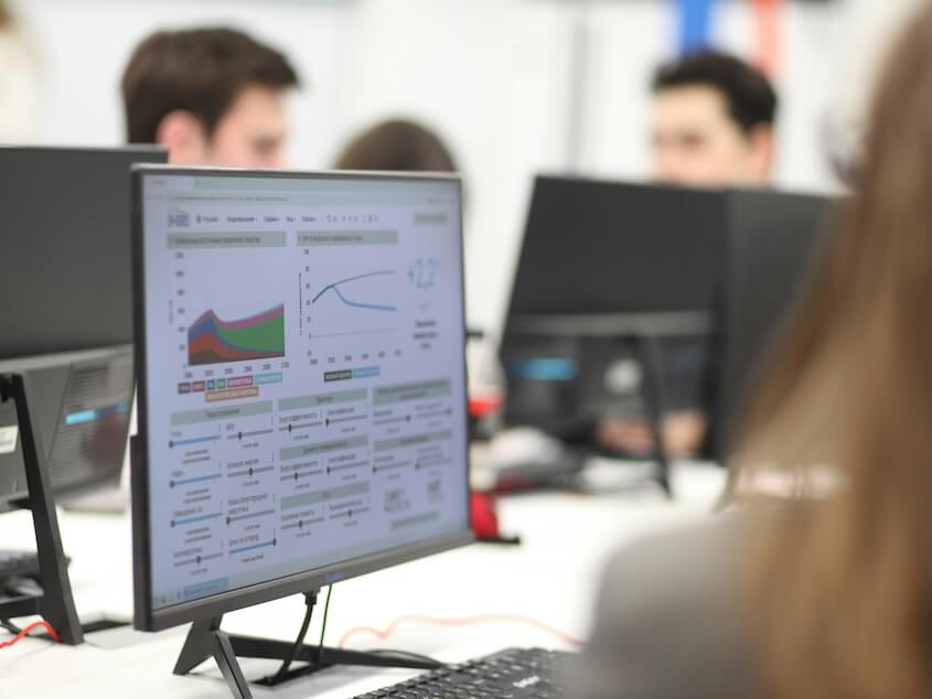 a group of people working on computers in a room