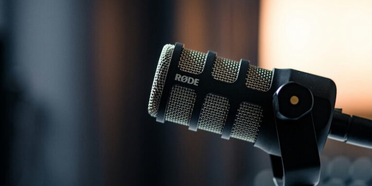 a close up of a microphone with a light in the background FEATURED IMAGE