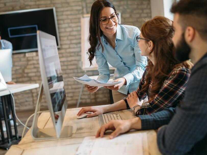 happy creative coworkers working in designer office