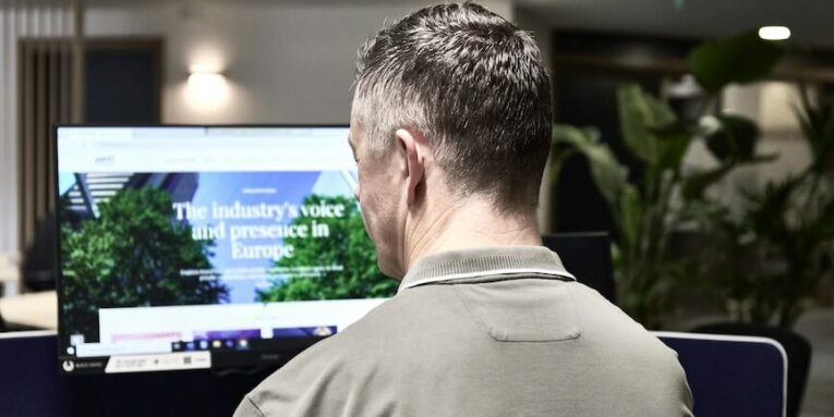 man working on a computer in an office FEATURED IMAGE
