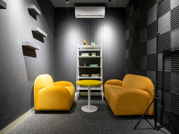 two yellow chairs in a podcast studio room