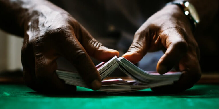 hands holding a card deck before starting FEATURED IMAGE