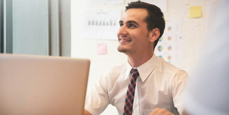 confident businessman smiling with working at the office FEATURED IMAGE