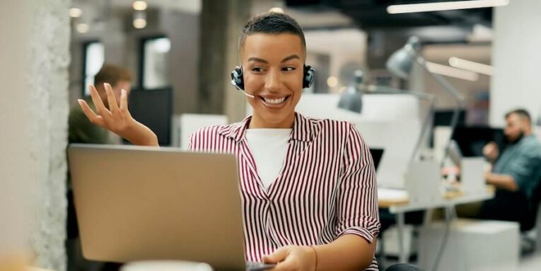 happy african american business woman using laptop while having video call in the office FEATURED IMAGE