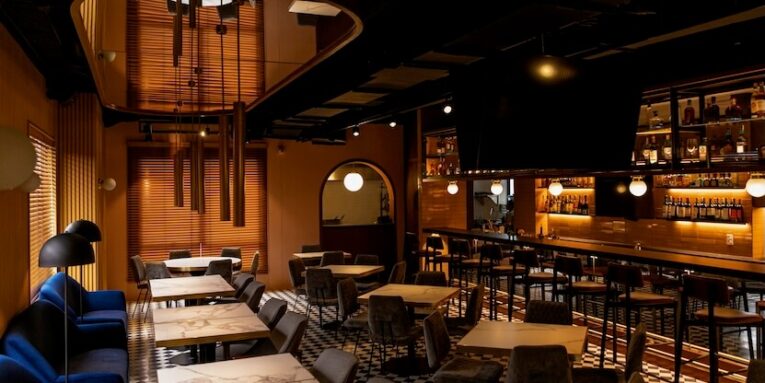 a restaurant with a checkered floor and tables FEATURED IMAGE
