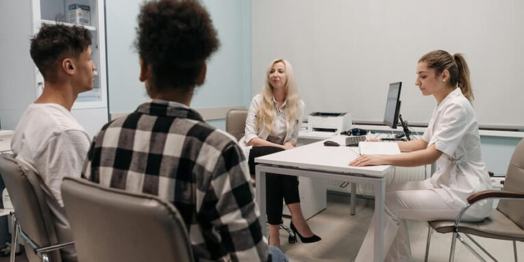Doctors talking with patients during a medical appointment in a clinic office setting FEATURED IMAGE