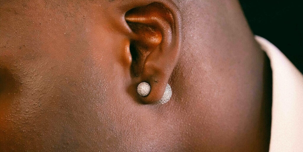 close up of a pearl earring in a dark earlobe FEATURED IMAGE