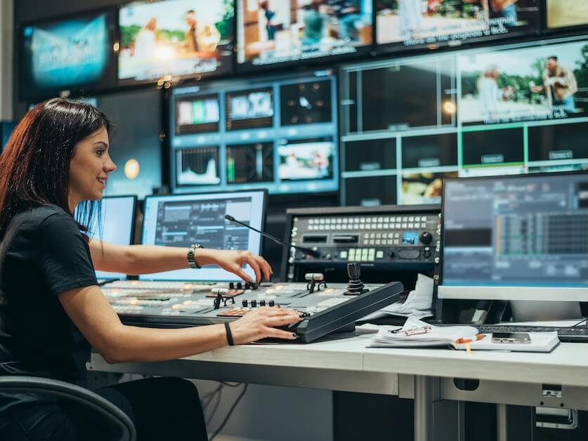 young beautiful woman working in a broadcast control room at a tv station