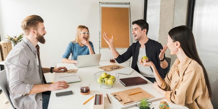 hilarious managers are discussing project they sitting around workplace and listening to their colleague who is jolly FEATURED IMAGE